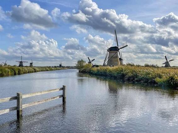 Windmills along the water in Kinderdijk, one of the best day trips from Amsterdam