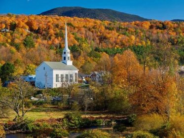 The iconic church in Stowe Vermont stands out beautifully in the fall foliage.