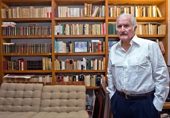 Mexican writer Carlos Fuentes poses in front of his library during an interview with the AFP news agency, in Mexico City, on November 6, 2008. Mexico launched, on November 11, 2008, a series of events including discussions, presentation of art works, operas, and conferences to pay tribute to the 80-year-old Fuentes, one of the most prolific Latin American writers, and also to celebrate the book which established his reputation 50 years ago, "La región mas transparente" ("The Most Transparent Region"). (AFP PHOTO/Ronaldo SCHEMIDT)
