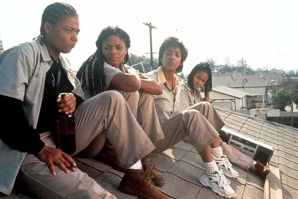 Queen Latifah, Kimberly Elise, Vivica Fox and Jada Pinkett all sitting on the roof of a house in a scene from the film 'Set It Off', 1996