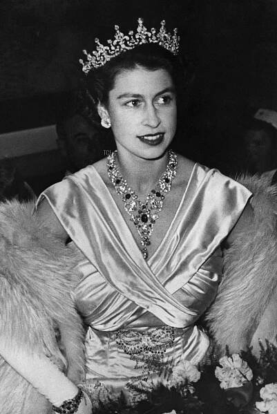 Princess Elizabeth wearing a tiara and carrying a bouquet of flowers at Warner Theatre London as she attends the premiere of the British film The Lady With A Lamp, 22 September 1951