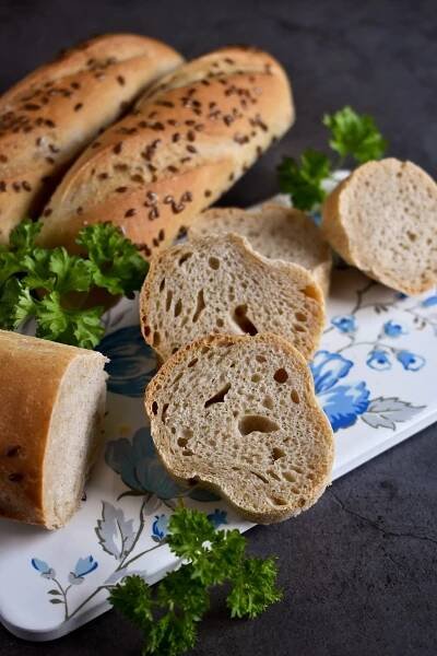 bread rolls and parsley on a blue and white floral design plate with green leafy garnish