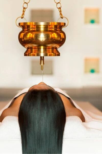 The Westin Siray Bay Resort & Spa, Phuket Exterior photo A practitioner administers shirodhara, a form of ayurvedic treatment, to a patient.