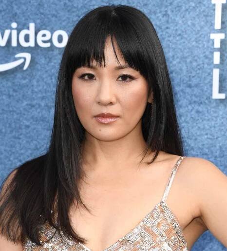 Constance Wu with long straight hair and wispy bangs