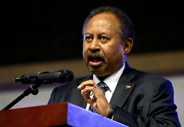 FILE PHOTO: Sudan's Prime Minister in the transitional government Abdalla Hamdok addresses people as they celebrate the first anniversary of the start of the uprising that toppled long-time ruler Omar al-Bashir, at the Friendship Hall in Khartoum