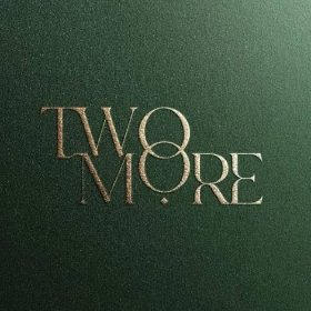 the logo for two more is shown on a green surface with silver lettering and a black background