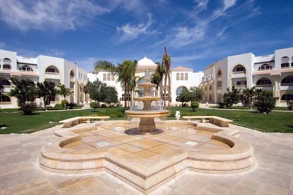 a fountain in a courtyard in front of a building at Old Palace Resort Sahl Hasheesh in Hurghada
