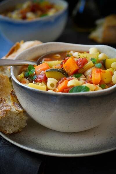 This vegan minestrone soup is made with veggies, white beans and pasta simmered in a flavourful, herby tomato broth. Easy to make and totally adaptable to your favourite seasonal veggies, this hearty and healthy soup is a satisfying meal year round!