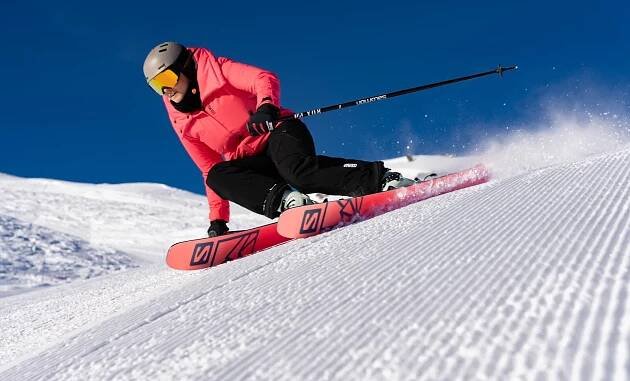 Skier on groomed slope