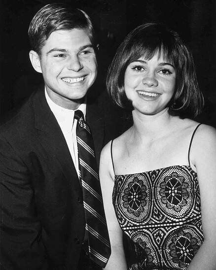 circa 1965: Portrait of American teen actor Sally Field, wearing a spaghetti-strip black lace dress, smiling next to her boyfriend, Steven Craig. Field and Craig were married from 1968 - 1975. (Photo by Jack Knox/Hulton Archive/Getty Images)