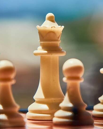 Free Artistic close-up of a wooden chessboard with queen and pawns in focus. Stock Photo