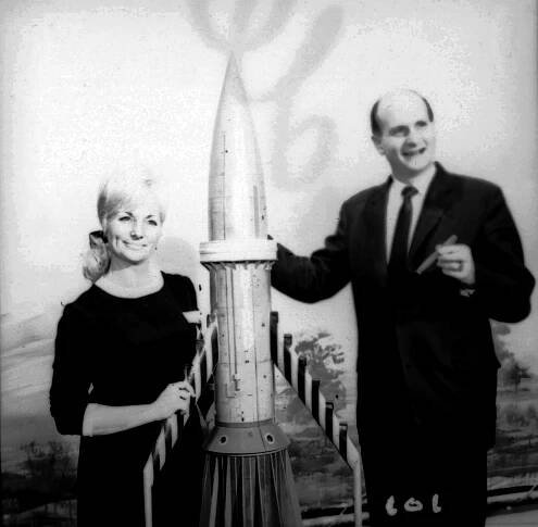 Black and white photo of Sylvia and Gerry Anderson with a model rocket.