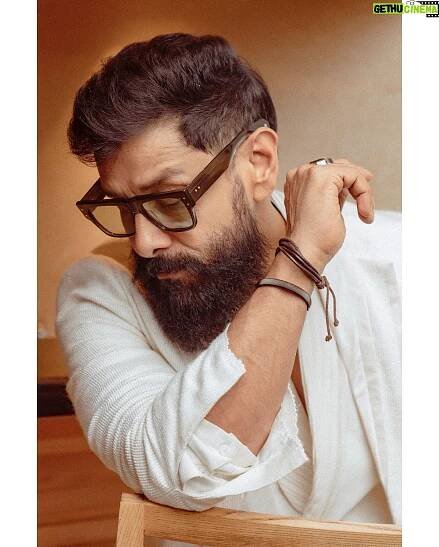 Vikram - 605.6K Likes - In a world of colours, be the shining white.  Styled by @ishabhansali. 📸 @puchi.photography. Outfit @antar_agni_ujjawaldubey
Accessories @ishhaara 
Sunglasses @rosvinbugs 
Shoes @whitemuds_official #thangalaanfromaug15