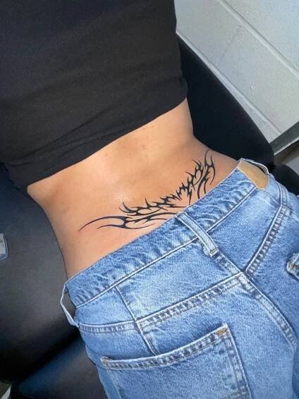 a woman with a tattoo on her stomach