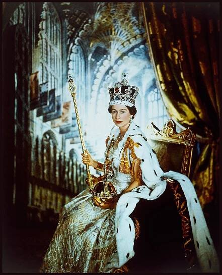 The Queen pictured in a crown with robes holding a pole-like object and a spherical object with the other hand known as the sovreign's orb