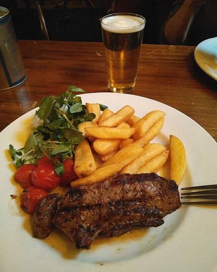 Plate of food with a pint of beer