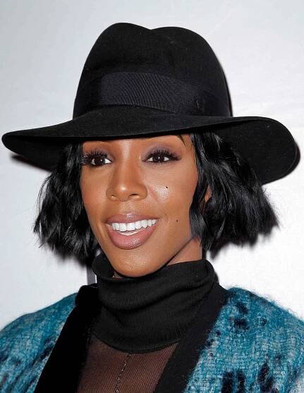 Kelly Rowland wearing a wavy bob cut with a black hat