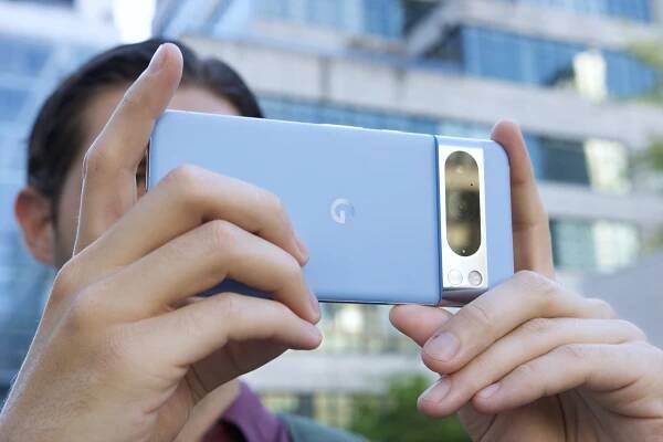 Someone taking a photo with the Google Pixel 8 Pro in a landscape orientation.