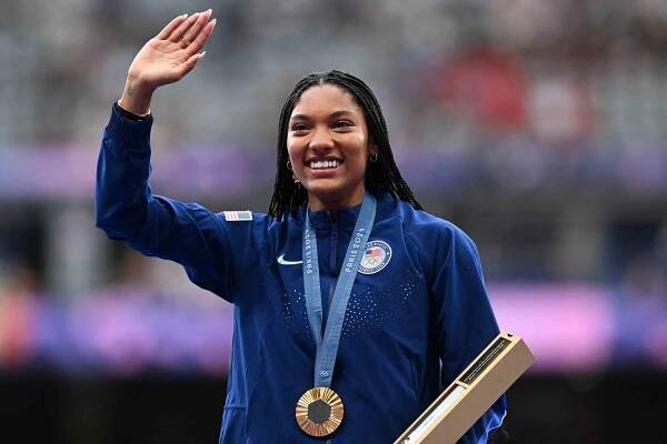 Gold medallist US' Tara Davis-Woodhall celebrates on the podium during the victory ceremony for the women's long jump athletics event during the Paris 2024 Olympic Games at Stade de France in Saint-Denis, north of Paris, on August 9, 2024.