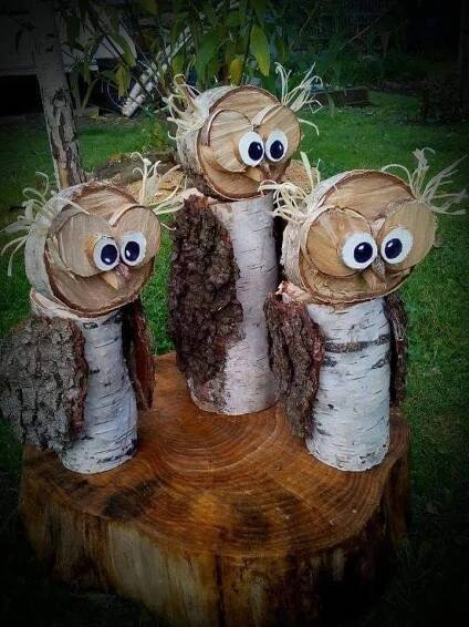 three little owls made out of tree trunks