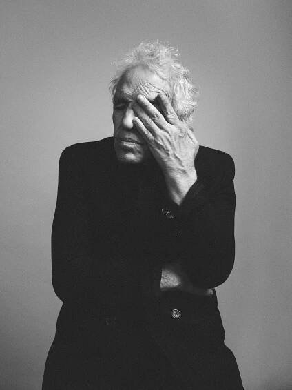 Saint Laurent Abel Ferrara photographed in black and white with his hand touching his eye produced by Maria Queralt.