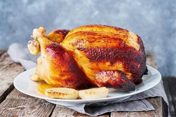 Grilled chicken in blue casserole on dark gray old wooden table