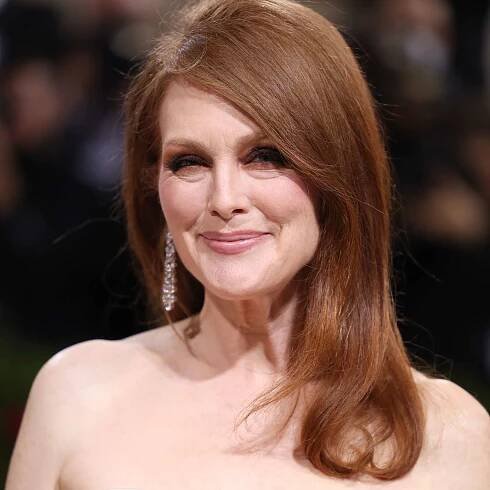 Julianne Moore wears a blown-out medium-length hairstyle with deep side part