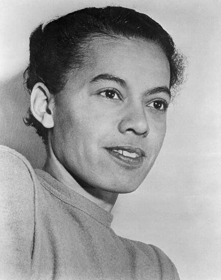 Black and white photo of a female with dark hair that is pulled back
