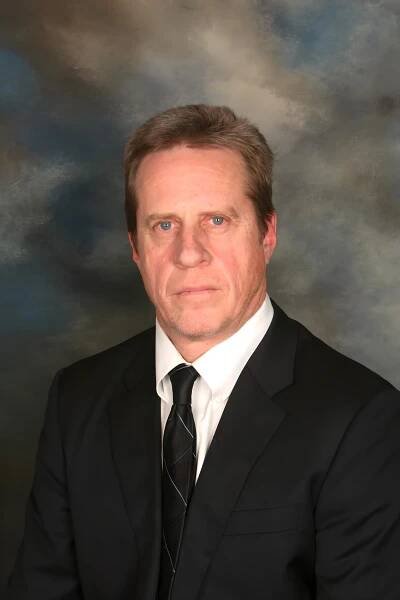 Portrait of Michael T. Carr, a distinguished man in a suit and tie