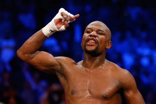 Floyd Mayweather Jr. celebrates after a welterweight boxing match.