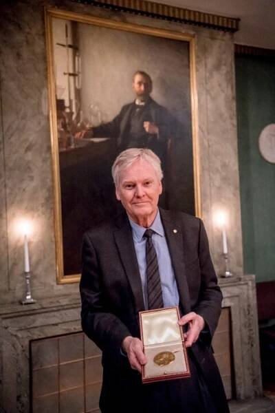 A man showing his medal