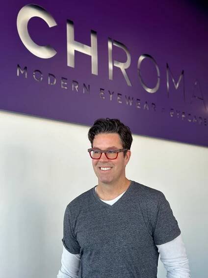 Dr. Matt Barber modeling a pair of Etnia frames glasses at CHROMA's practice in Fort Worth.