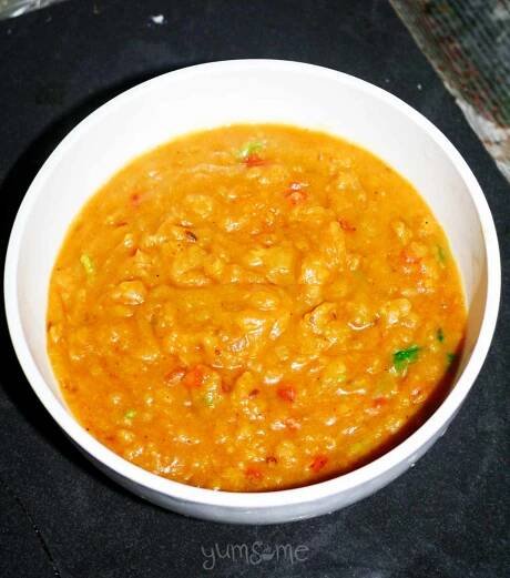 A white bowl containing sambar.