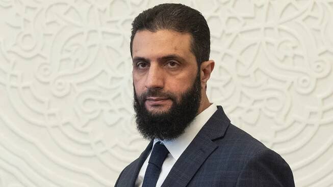 FILE - Syria's de facto leader Ahmad al-Sharaa, formerly known as Abu Mohammed al-Golani, walks in the presidential palace ahead of his meeting with Walid Ellafi, Libyan minister of state for communication and political affairs, in Damascus, Dec. 28, 2024. (AP Photo/Mosa'ab Elshamy, File)
