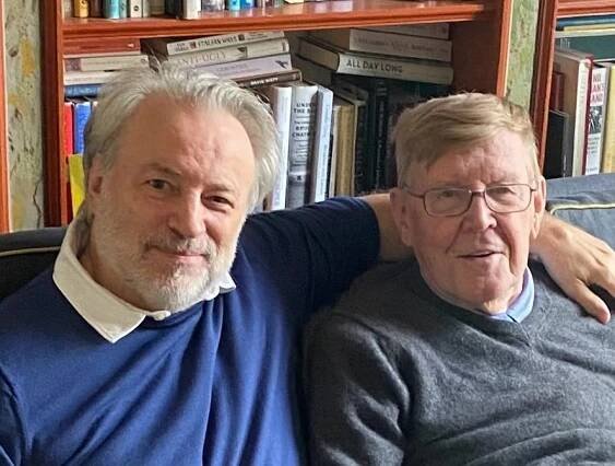 Keith McNally in a blue sweater with a white shirt, Alan Bennett in a grey sweater and blue shirt.