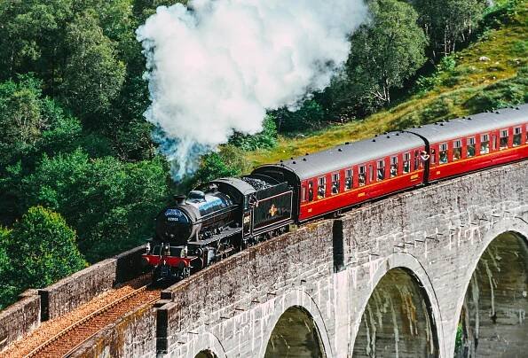 The Jacobite steam train, also known as the Hogwarts Express, crossing the Glenfinnan Viaduct.