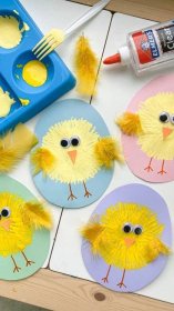 paper plates with yellow chicks on them next to paintbrushes and other crafting supplies