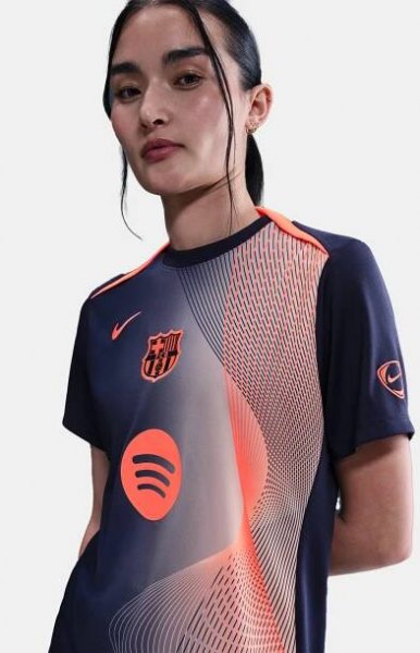 FC Barcelona navy training shirt with coral Nike logo, Spotify sponsor, and geometric coral and white pattern design on the shoulder and chest