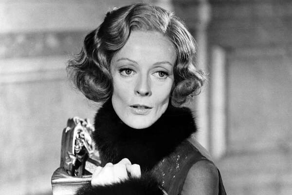 Maggie Smith leaning up on chair in a scene from the film 'Travels With My Aunt', 1972. 