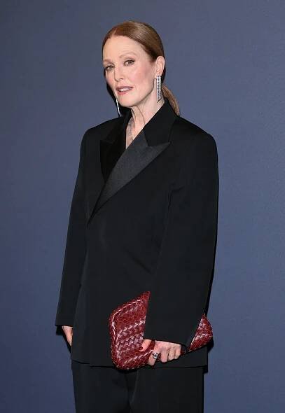 Julianne Moore attends the Kering Women in Motion event in a black Bottega Veneta suit and a woven clutch.
