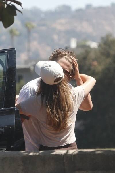 Jeremy Allen White kissing Addison Timlin's cheek.