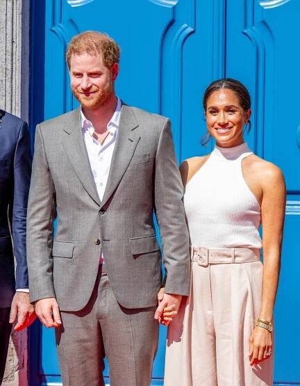 Prince Harry and Meghan Markle holding hands.