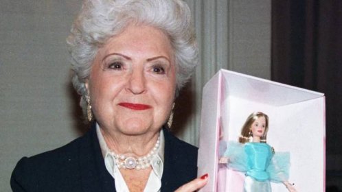 An image of Ruth Handler holding up a Barbie doll. 
