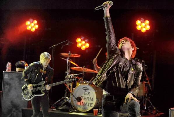 Gerard Way and Mikey Way of My Chemical Romance performing on stage.