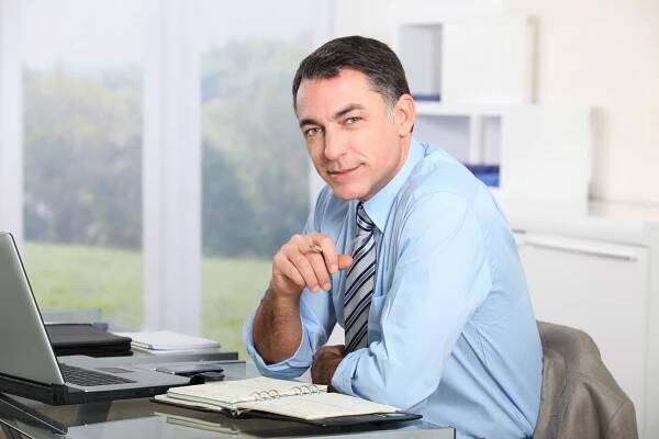 Closeup of office worker in the office — Stock Photo © Goodluz #18249563