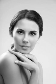 Portrait of beautiful young woman with naked shoulders, on grey background. Portrait of beautiful young woman with naked shoulders, on grey background
