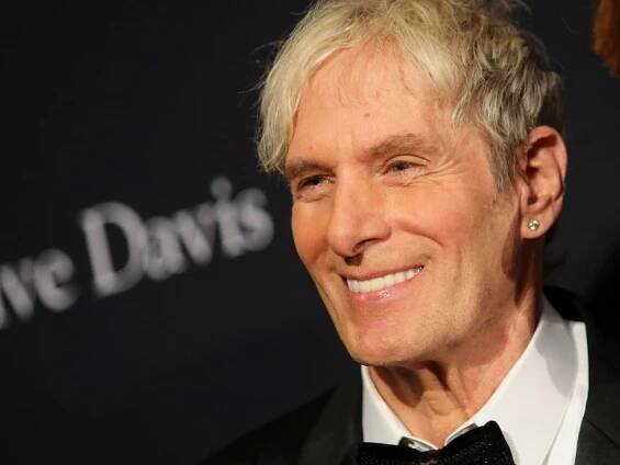 A close up image of Michael Bolton smiling on the red carpet before the Grammys