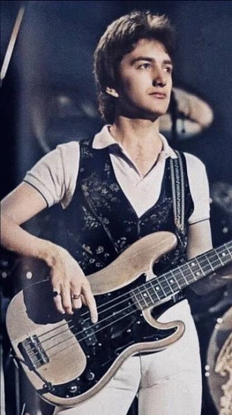 a young man is playing an electric guitar