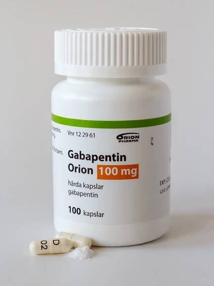 Gabapentin Orion 100mg capsules bottle with pills and spilled powder.