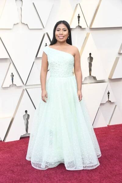 Yalitza Aparicio on the red carpet wearing a light blue dress at the 2019 Oscars